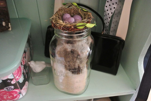 Wide mouth mason jar from Value Village, as well as the bird's nest. Baby bird is old, and the purse is available in my etsy shop.