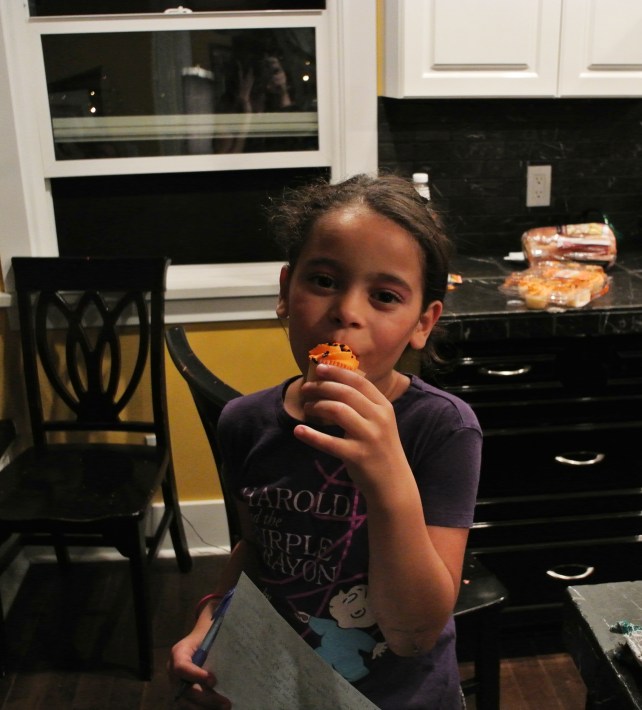 This is how a demure young lady eats a Halloween cupcake.