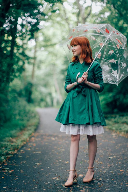 green trench with a dress and flats.
